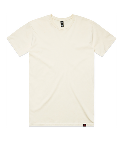 An off-white crewneck t-shirt laid flat against a solid white background, featuring a small black brand tag at the inner collar and a tiny red tag near the bottom hem.
